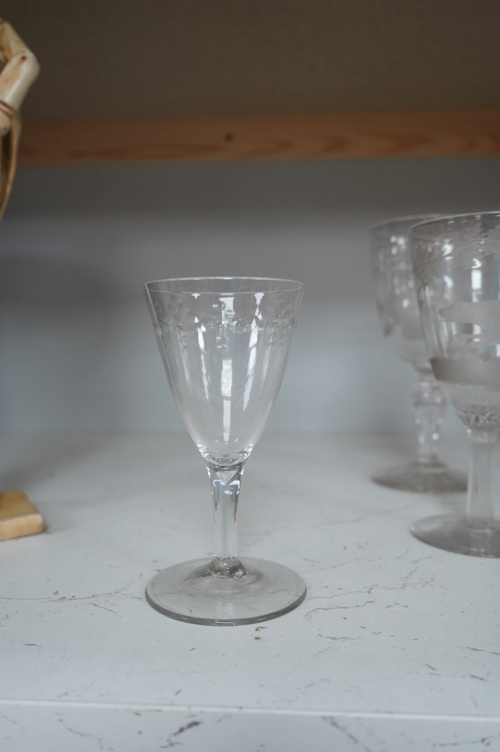 A Victorian Stourbridge wine glass, the bowl engraved with a running rabbit, together with six other glasses, tallest 19cm (7). Condition - good